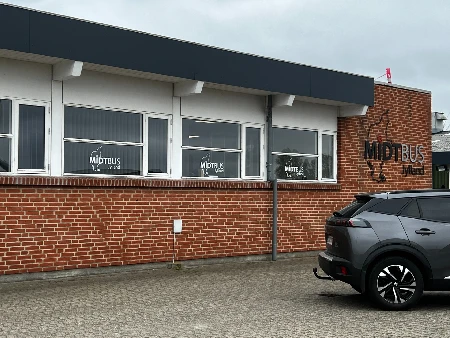 MIDTBUS kontorfacade med folie og logo i vinduerne